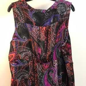 Beautiful plus size sleeveless blouse with soft ruffles and a flattering cut.